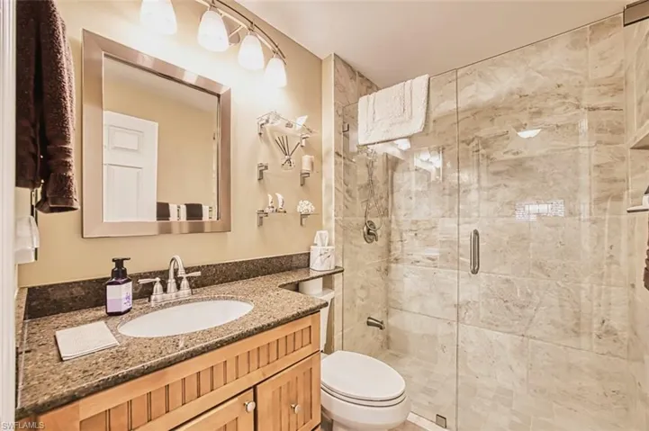 Full bath with vanity and a shower stall