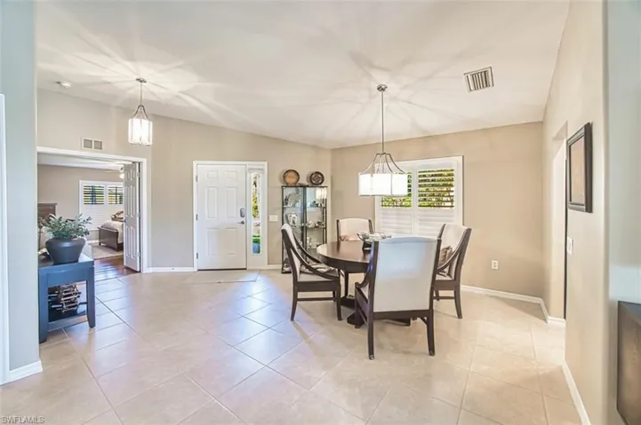 Dining room with light tile patterned floors and baseboards