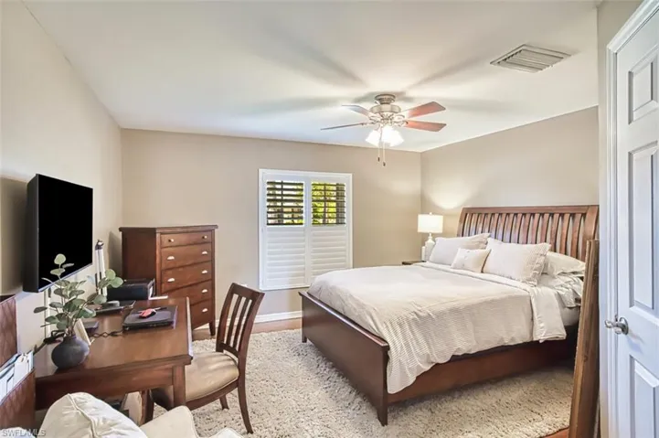 Bedroom with a ceiling fan and wood finished floors