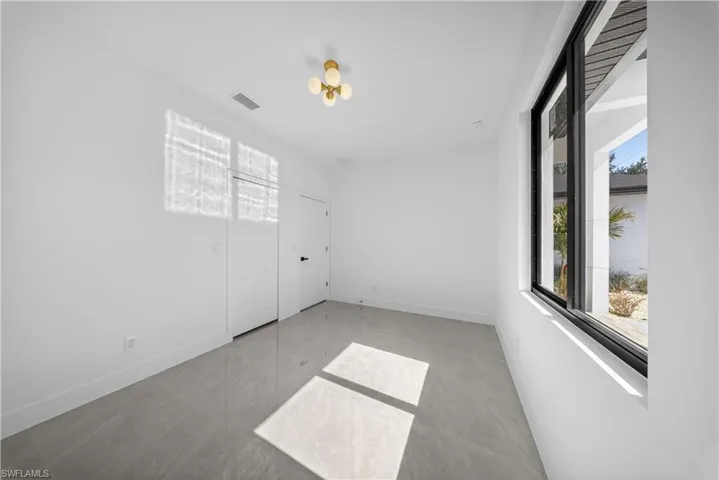 Unfurnished room featuring healthy amount of natural light