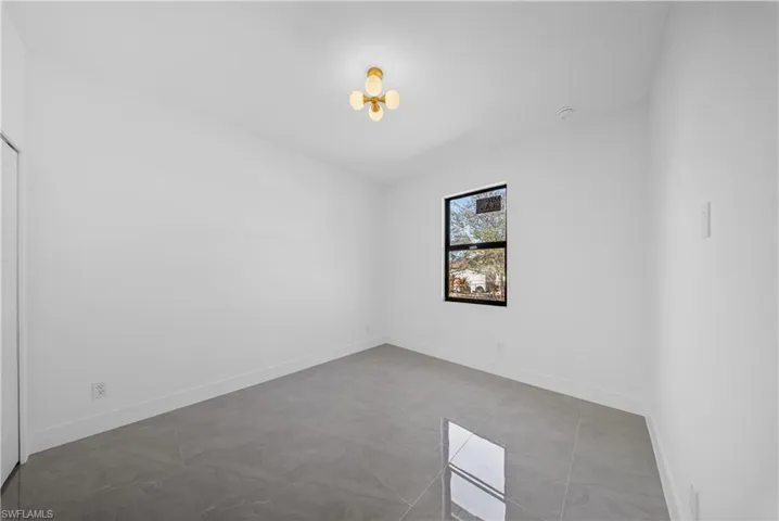 Empty room featuring baseboards