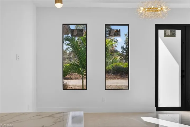 Entryway with a chandelier and light tile patterned floors