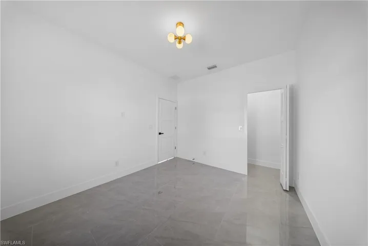 Spare room featuring baseboards