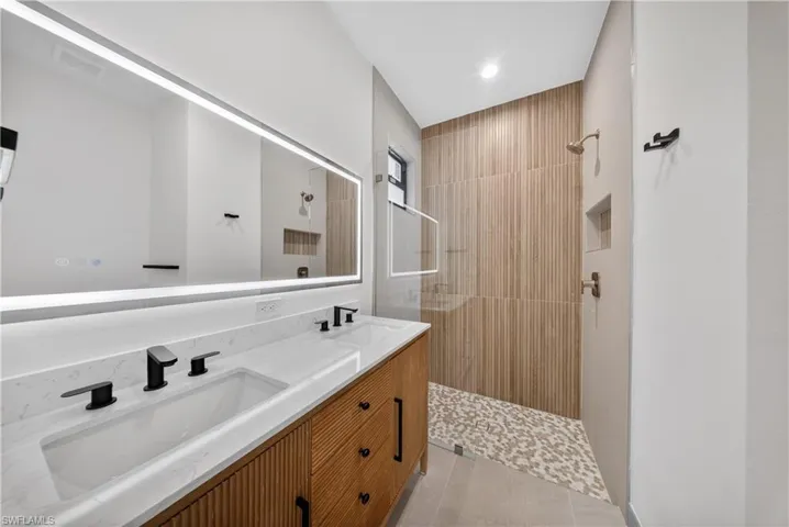 Bathroom with double vanity and a walk in shower