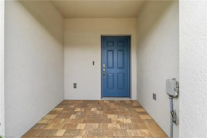 Entrance to property with stucco siding
