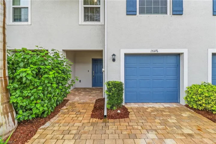 Property entrance with stucco siding and a garage