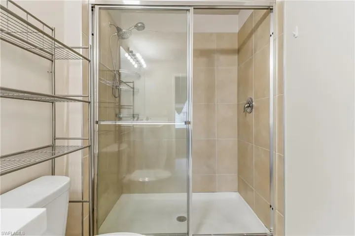 Full bathroom with a stall shower and toilet