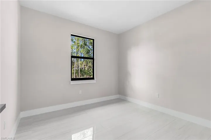 Empty room featuring baseboards