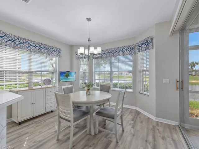 Dining room with light wood-style flooring, baseboards, and a chandelier
