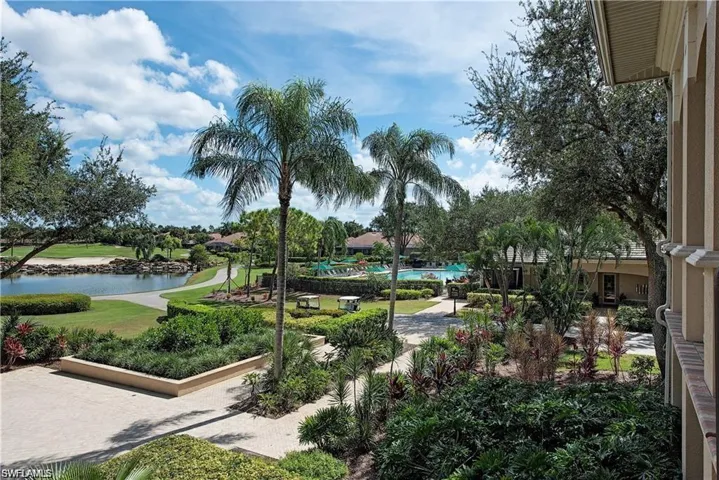 View of home's community featuring a water view and a yard