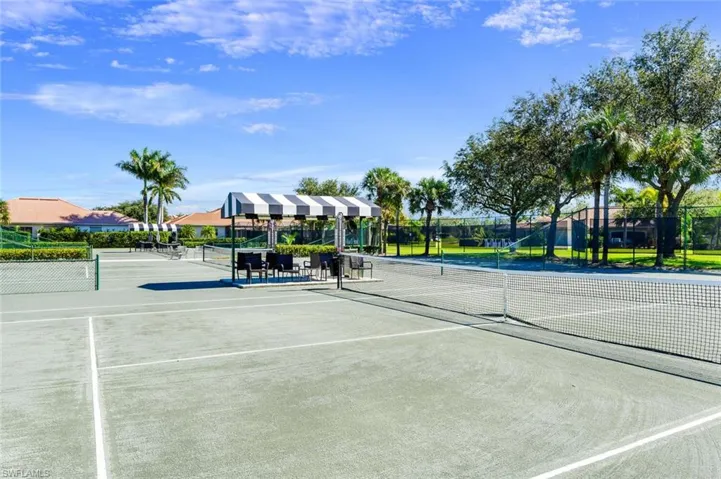 View of tennis court featuring fence