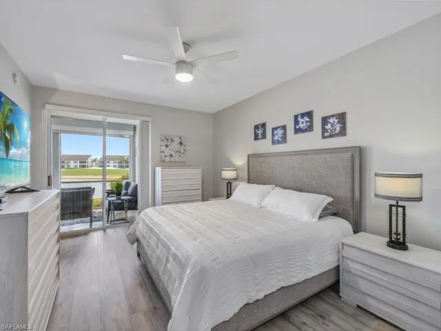 Bedroom with access to exterior, ceiling fan, and wood finished floors