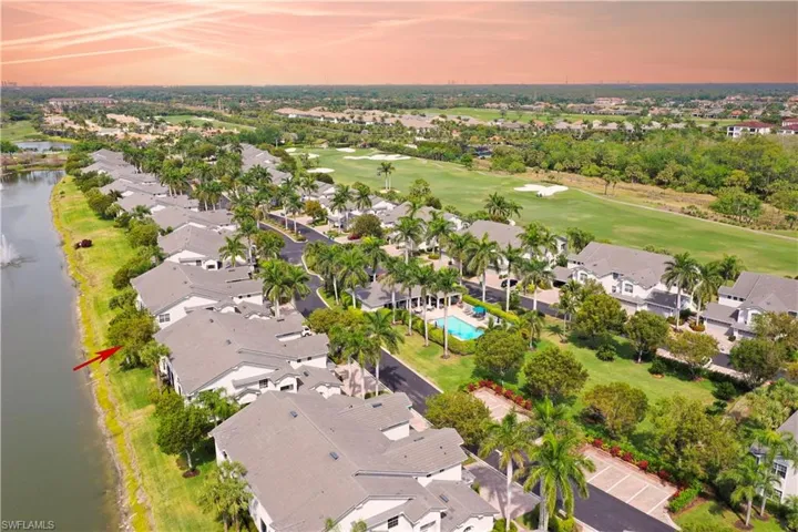 Drone / aerial view with view of golf course, a residential view, and a water view