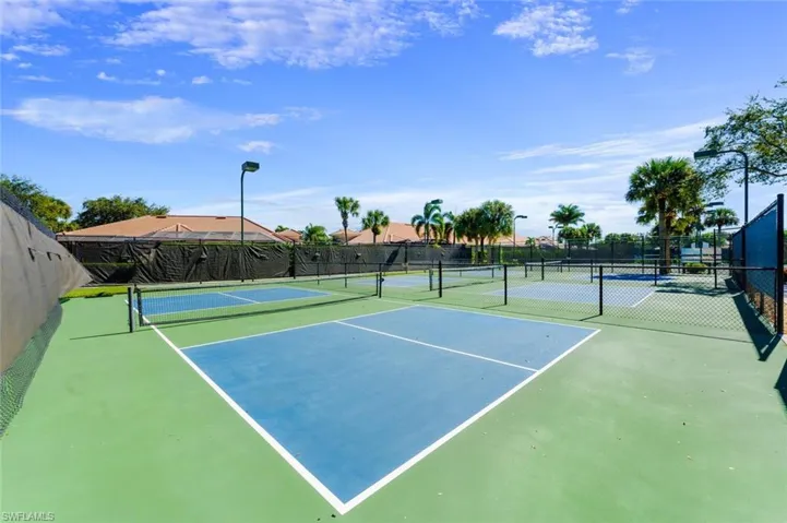 View of tennis court featuring fence