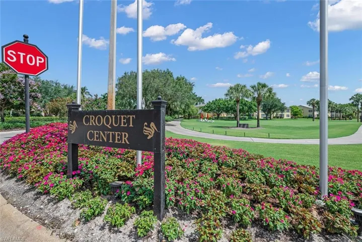 Community / neighborhood sign with a yard