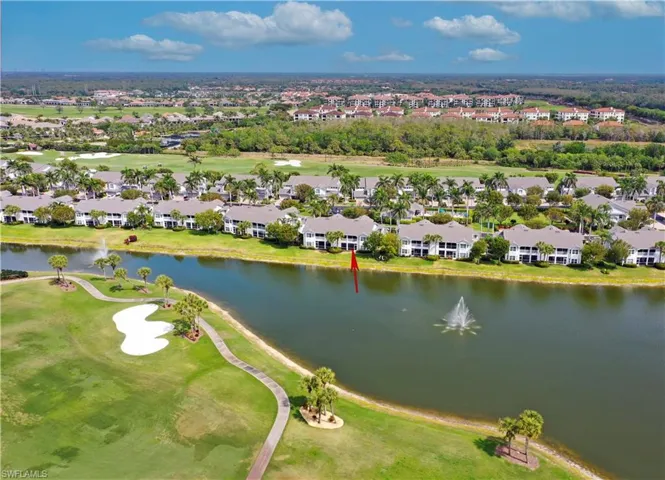 Drone / aerial view featuring a water view, view of golf course, and a residential view