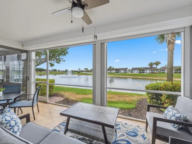 Sunroom featuring a water view, ceiling fan, and a wealth of natural light