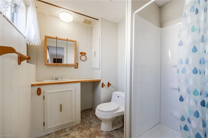 Full bath with toilet, a shower with shower curtain, and vanity