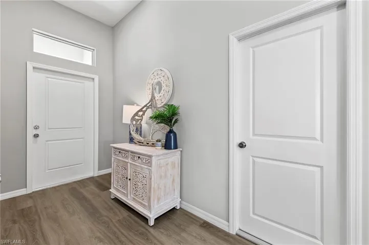 Entrance foyer featuring wood finished floors and baseboards
