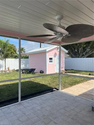 Unfurnished sunroom with ceiling fan