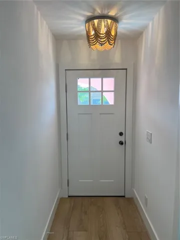 Doorway to outside featuring wood finished floors