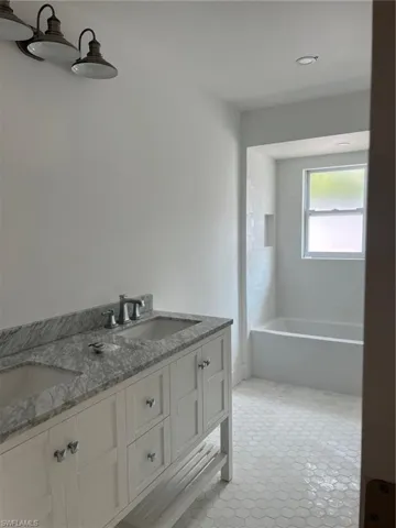 Full bath featuring double vanity