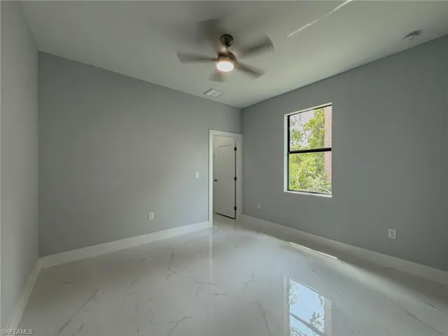 Room #2 with baseboards, visible vents, ceiling fan, and marble finish floor