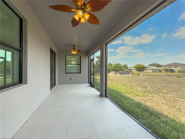 Unfurnished sunroom featuring a ceiling fan