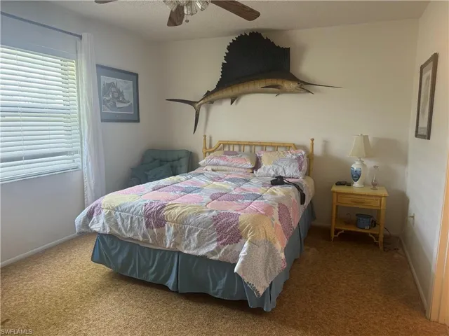 Bedroom with ceiling fan and carpet flooring