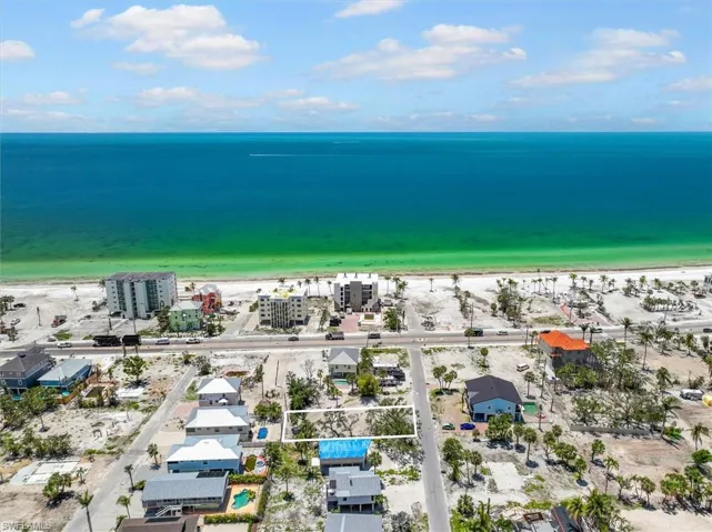 Drone / aerial view featuring a view of the beach and a water view