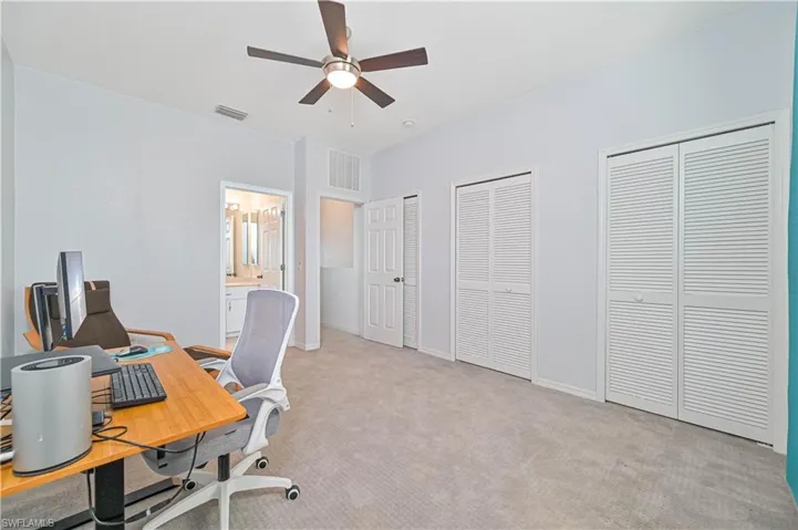 Carpeted office with ceiling fan