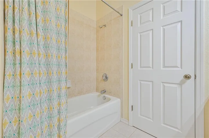 Bathroom featuring tile patterned floors and tiled shower / bath