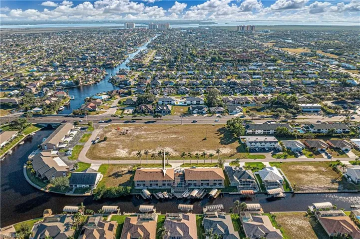 Birds eye view of property with a water view