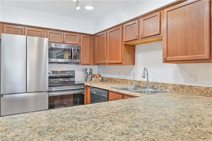 Kitchen featuring sink and appliances with stainless steel finishes