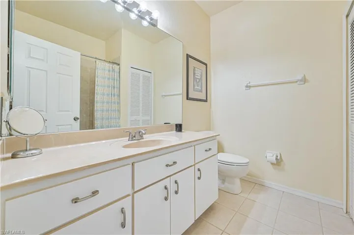 Bathroom with tile patterned flooring, vanity, and toilet