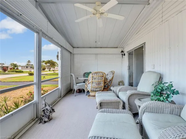 Sunroom / solarium with ceiling fan and vaulted ceiling