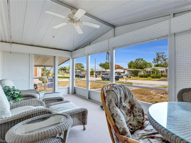 Sunroom / solarium featuring ceiling fan and vaulted ceiling