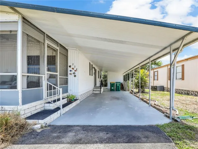 View of parking with a carport