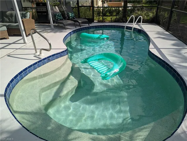 Outdoor pool with a patio area and a lanai
