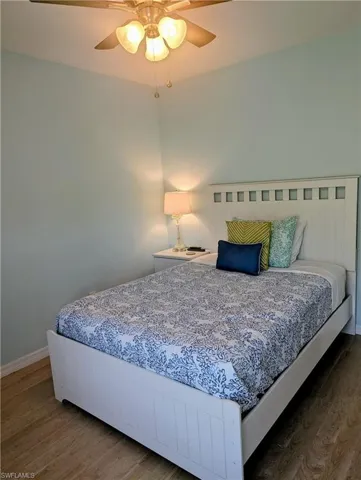 Bedroom featuring wood finished floors and a ceiling fan