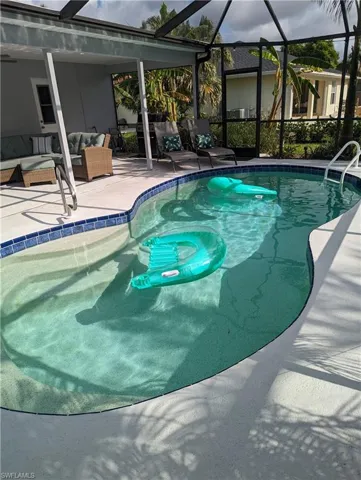 Outdoor pool with a patio, a lanai, and outdoor lounge/sitting area, 2 sun loungers