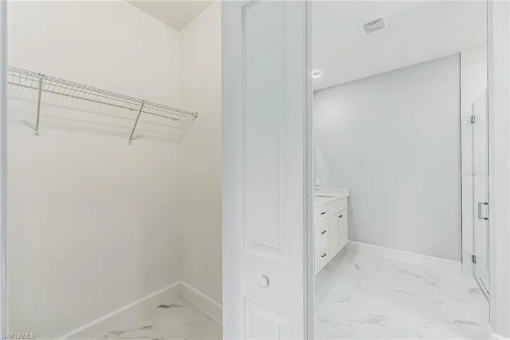 Spacious closet featuring light tile floors