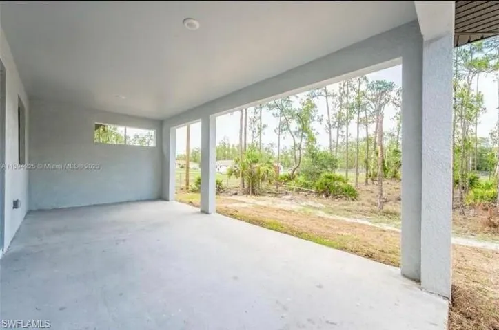 Tiled empty room featuring a tray ceiling