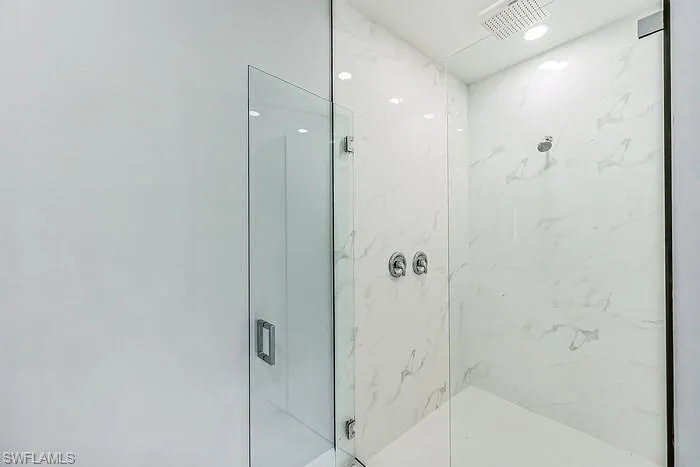 Bathroom featuring a shower with door