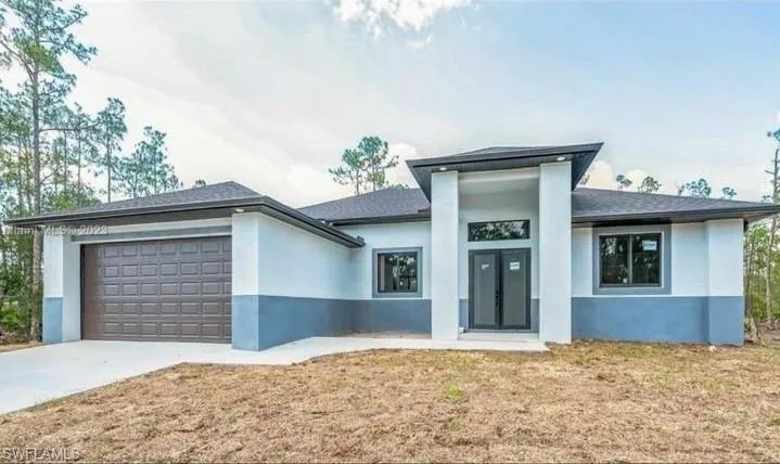 Prairie-style home featuring a garage
