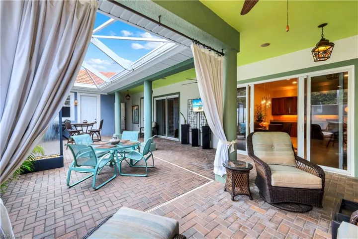 ADDED OUTDOOR DRAPERY CREATES A INTIMATE QUIET SITTING AREA