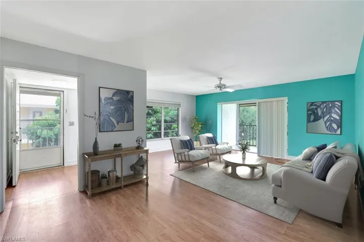 Living room featuring wood finished floors and ceiling fan; Virtually Staged