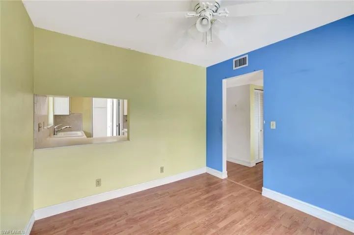 Spare room with ceiling fan, wood finished floors, baseboards, and a sink