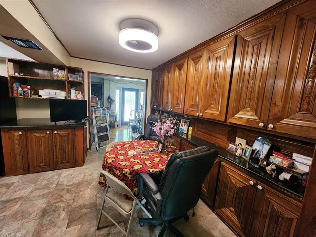 Dining room featuring light stone finish flooring and built in desk