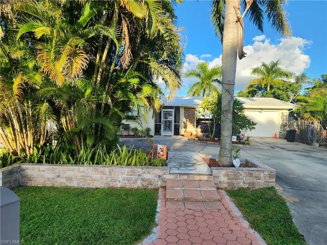 View of front facade with concrete driveway and an attached garage. Walkways to Mailbox so you dont have to get mail from streetside.
